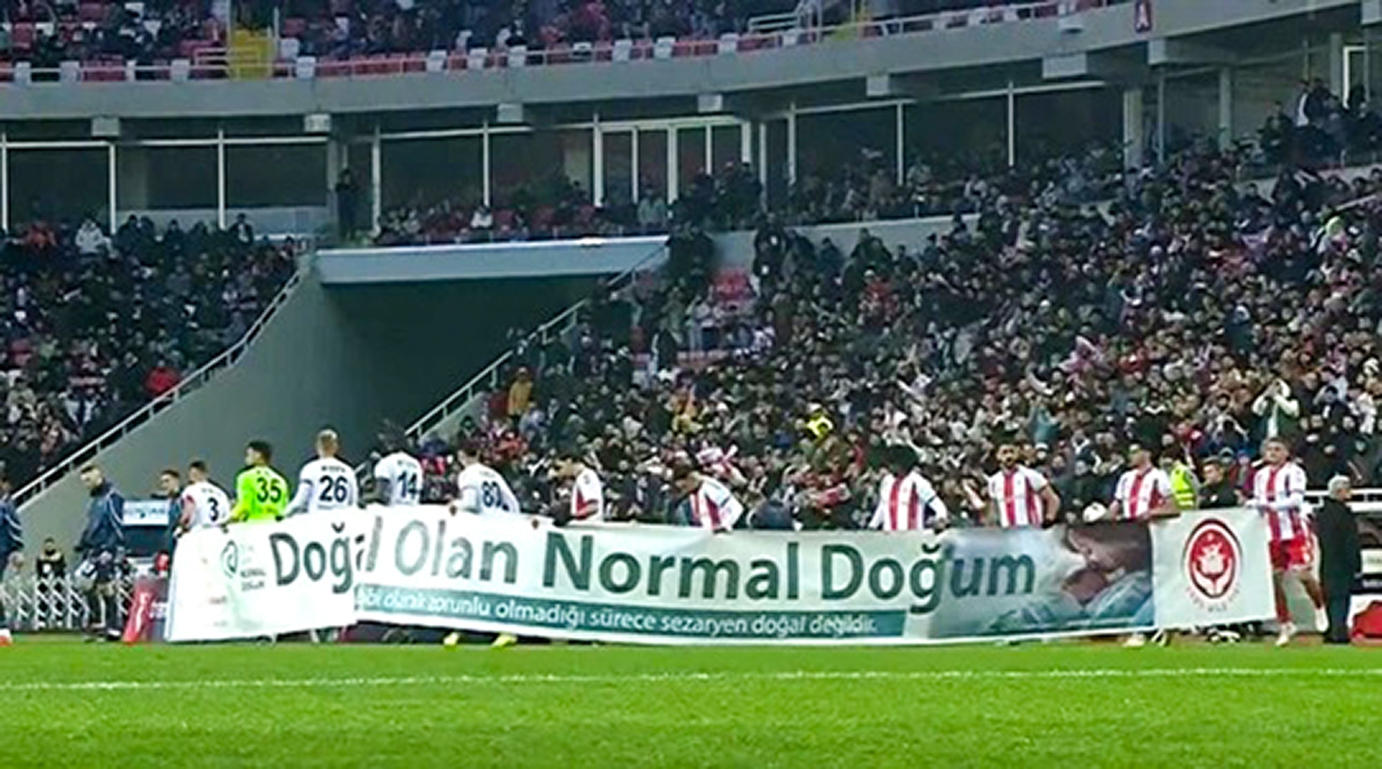 BANNER BAN: Bizarre Moment Footballers Promote Natural Birth Over Ceasarean Ops - Article cover image