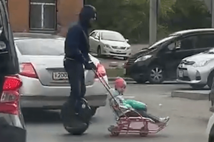 UN-NUTTER - Man On Unicycle Pushes Child Through Traffic For Social Media Likes - Article cover image