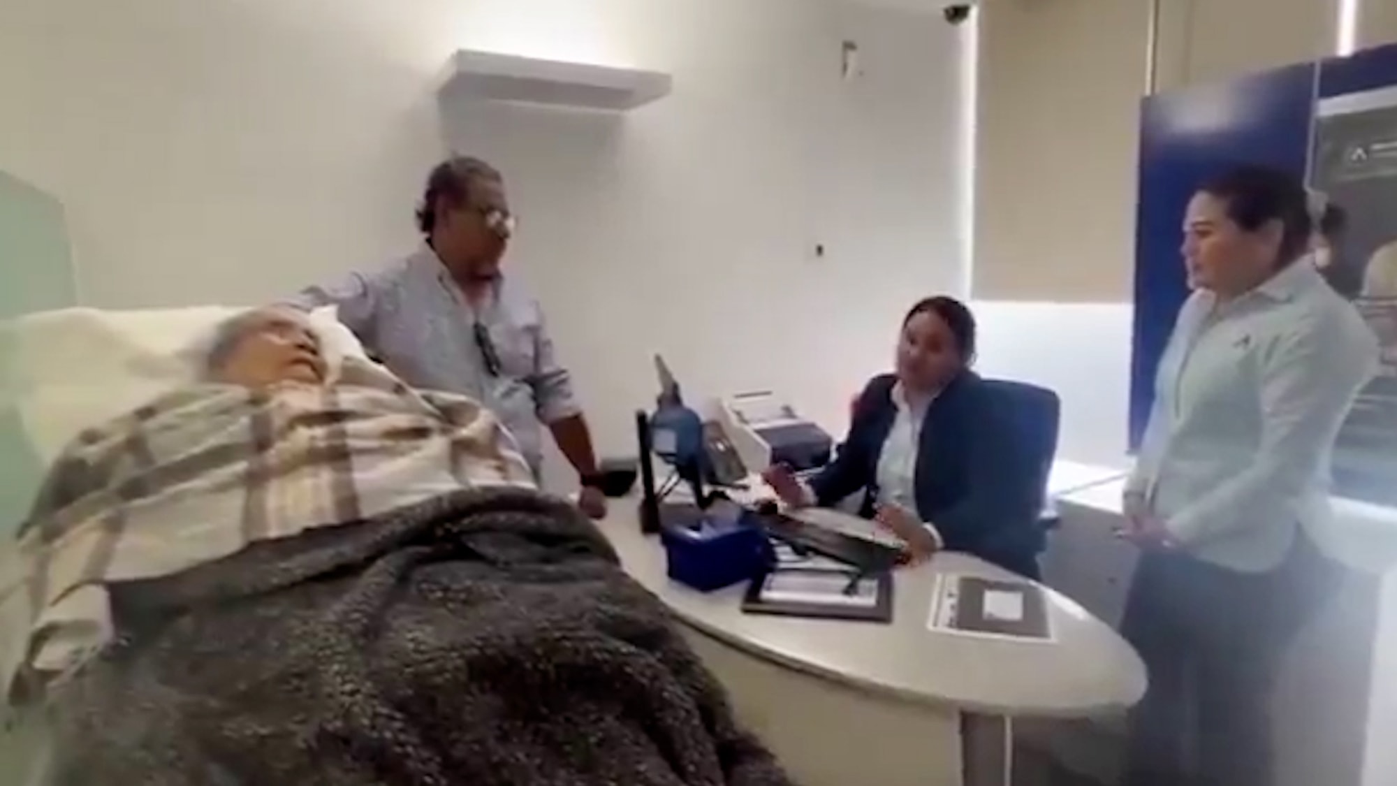 OFF THEIR TROLLEY - Bank Forces 96-Year-Old Woman To Come To Bank On Hospital Gurney To Prove Her ID - Article cover image